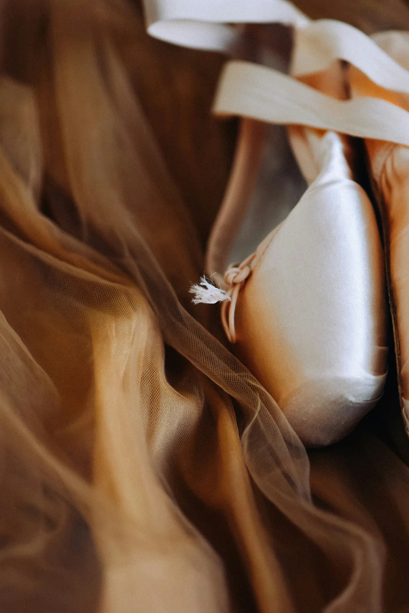 Pointe shoes and ankles during a pointe technique lesson.